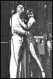 A person and person dancing on stage

Description automatically generated