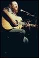 A person playing guitar and singing

Description automatically generated