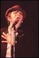 A person in a hat speaking into a microphone

Description automatically generated with medium confidence