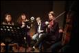 A group of people playing instruments

Description automatically generated