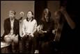 A group of people performing on a stage

Description automatically generated with medium confidence