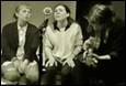 A group of people sitting next to a microphone

Description automatically generated with medium confidence