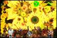 A group of people standing in front of a large yellow flower

Description automatically generated with low confidence