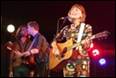 A person singing into a microphone with a guitar

Description automatically generated with low confidence