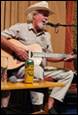 A person playing guitar and singing

Description automatically generated