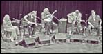 A group of people playing instruments

Description automatically generated