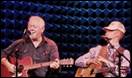 A couple of men playing guitars

Description automatically generated