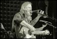A person singing into microphones

Description automatically generated