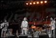 A blurry image of a band on stage

Description automatically generated